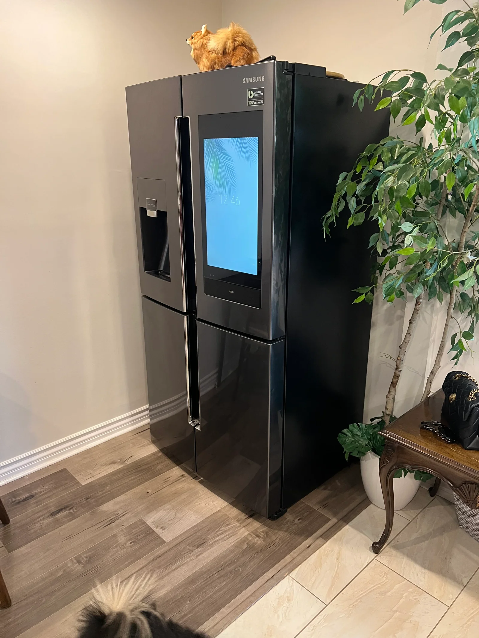 Black Samsung French-door refrigerator with smart display screen installed in kitchen