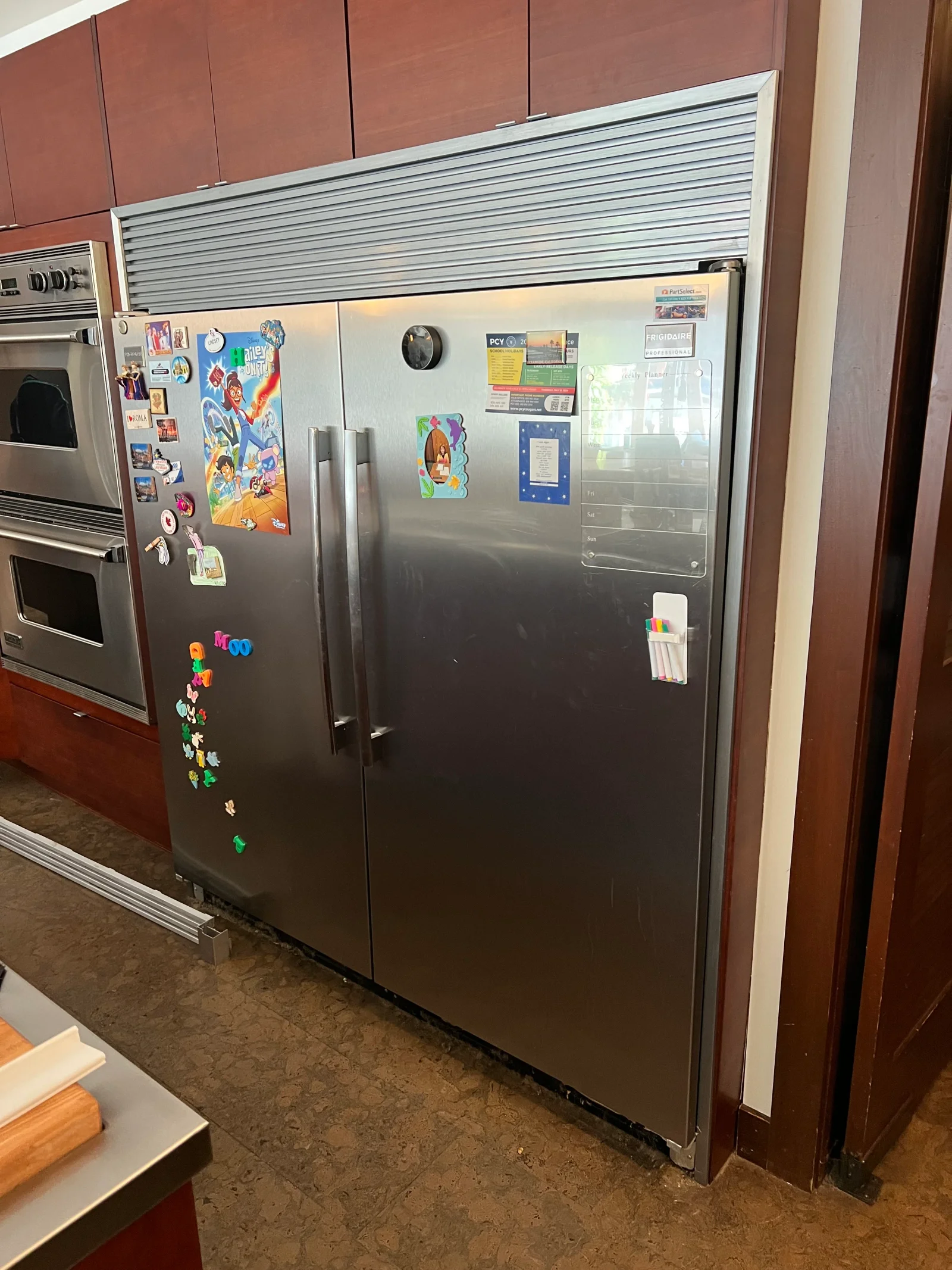 Stainless steel side-by-side refrigerator with French doors, ice/water dispenser, and adjustable shelves