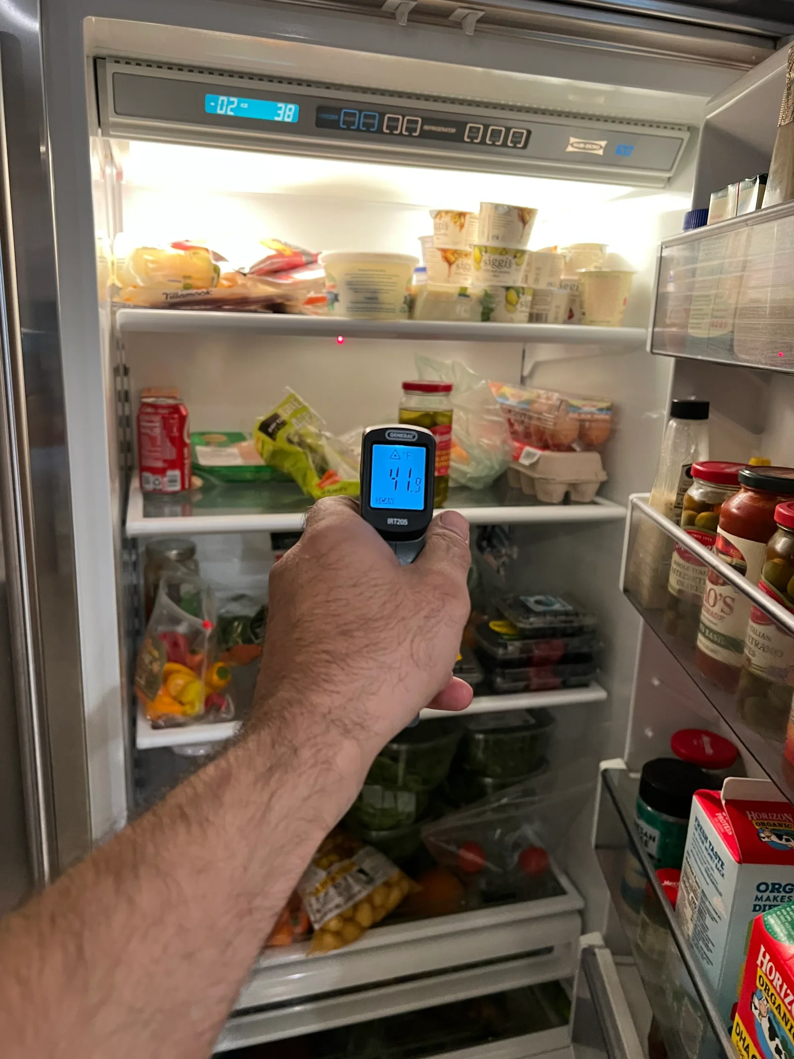 Digital thermometer reading refrigerator interior temperature during diagnostic service