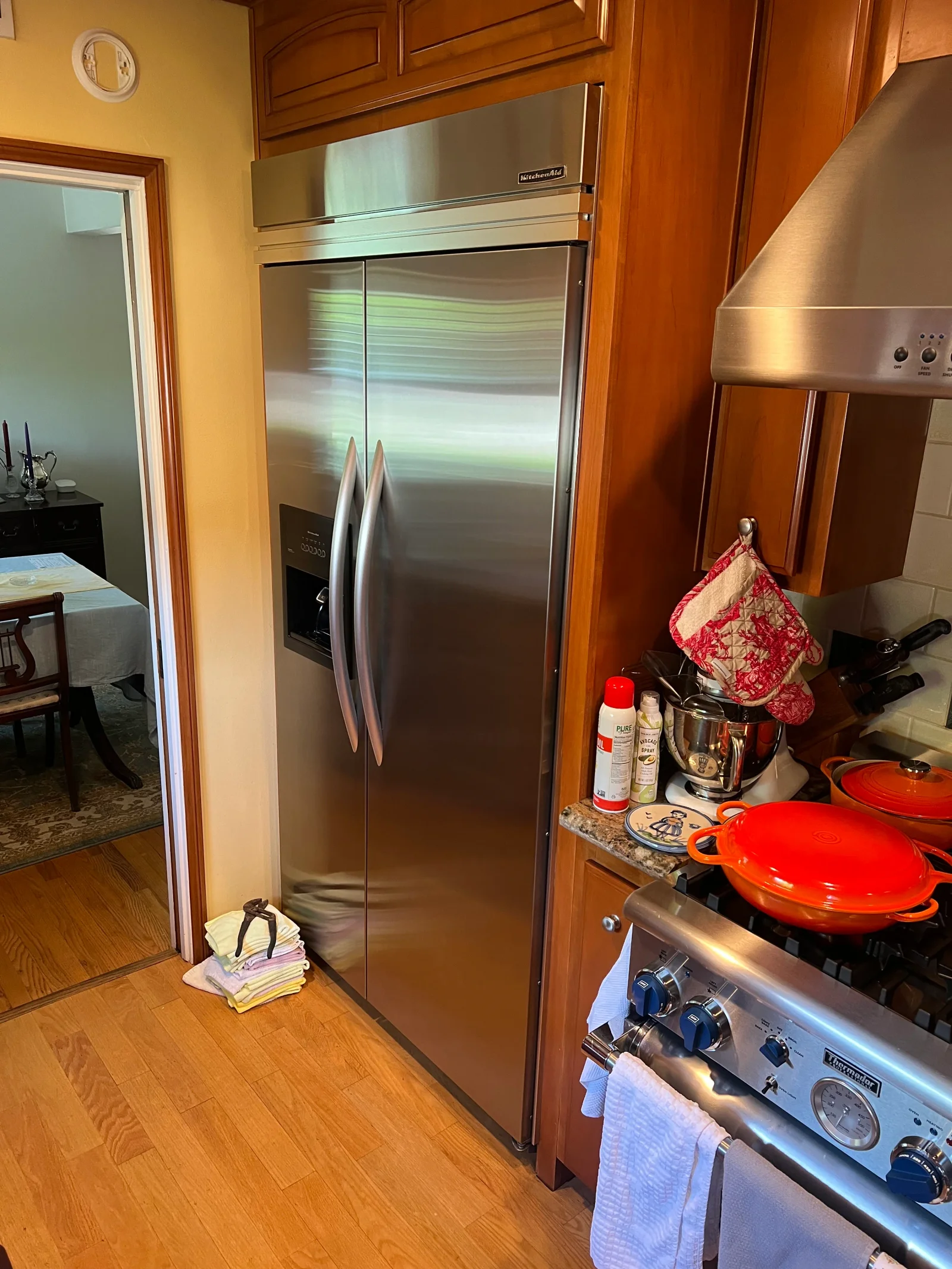 Stainless steel built-in side-by-side refrigerator with French doors installed in wood cabinetry