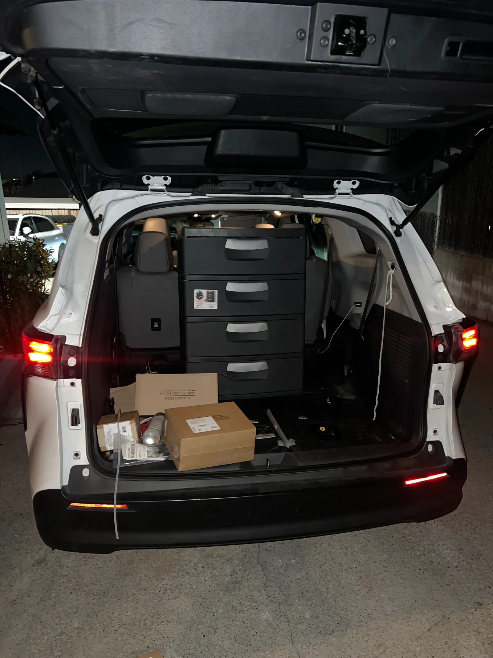 Service van cargo area with black drawer unit and boxed appliances ready for delivery and installation